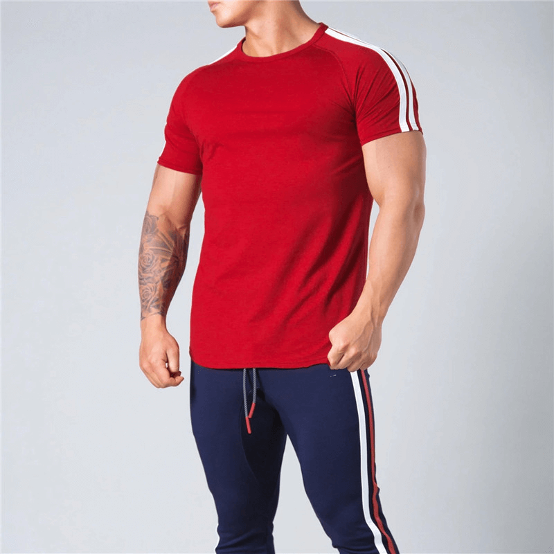 Man wearing red cotton t-shirt with striped sleeves, perfect for running and comfort. Short-sleeved, O-neck. Stylish men's fashion.